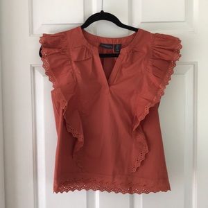 rust-colored blouse